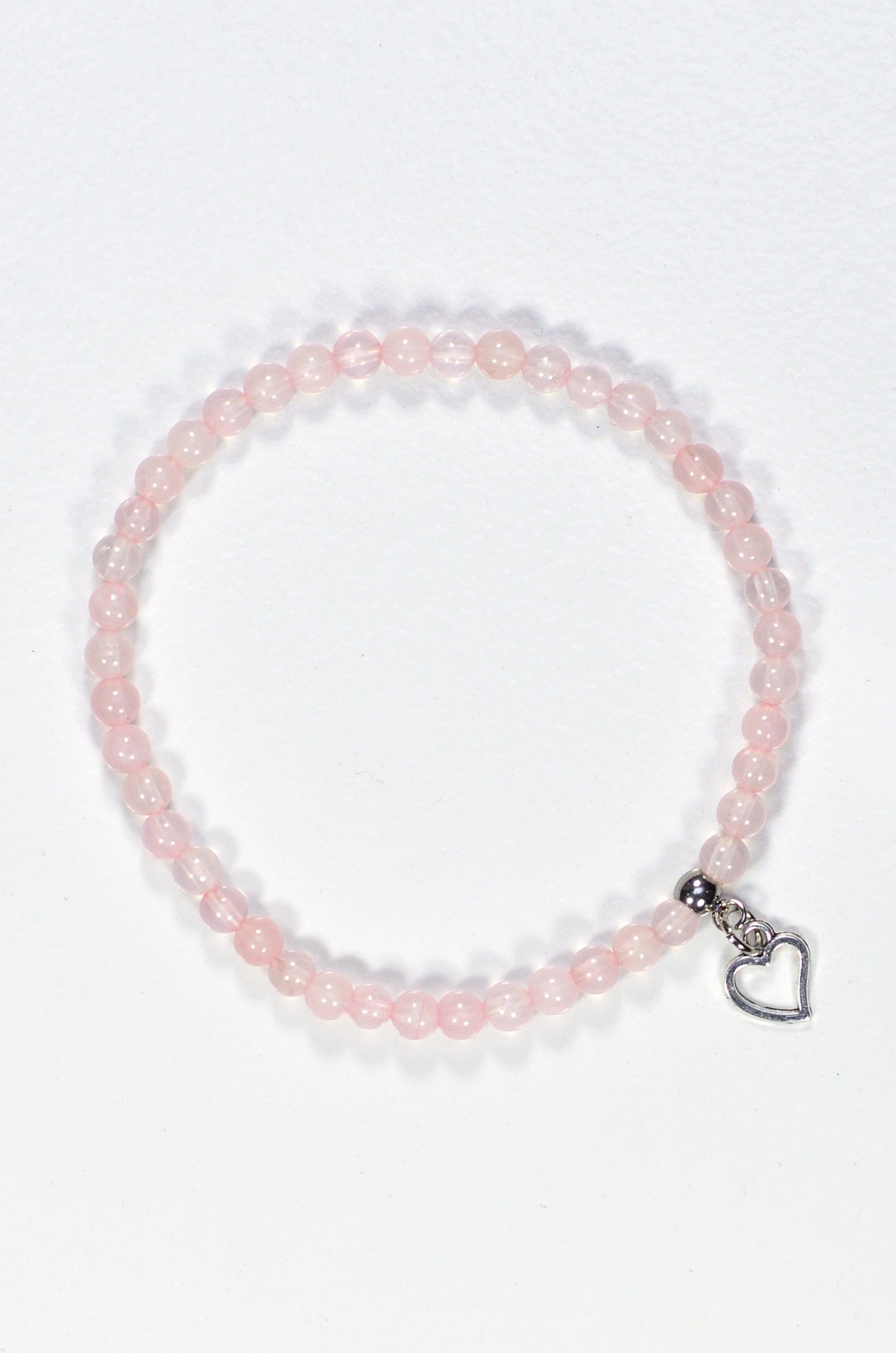 Top view of 4mm Rose Quartz Bracelet with Heart Charm.