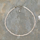 4mm Rose Quartz Crystal Choker Necklace beside a dime.