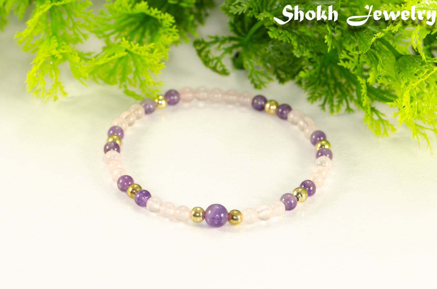4mm Rose Quartz and Amethyst Bracelet with gold plated accent beads.