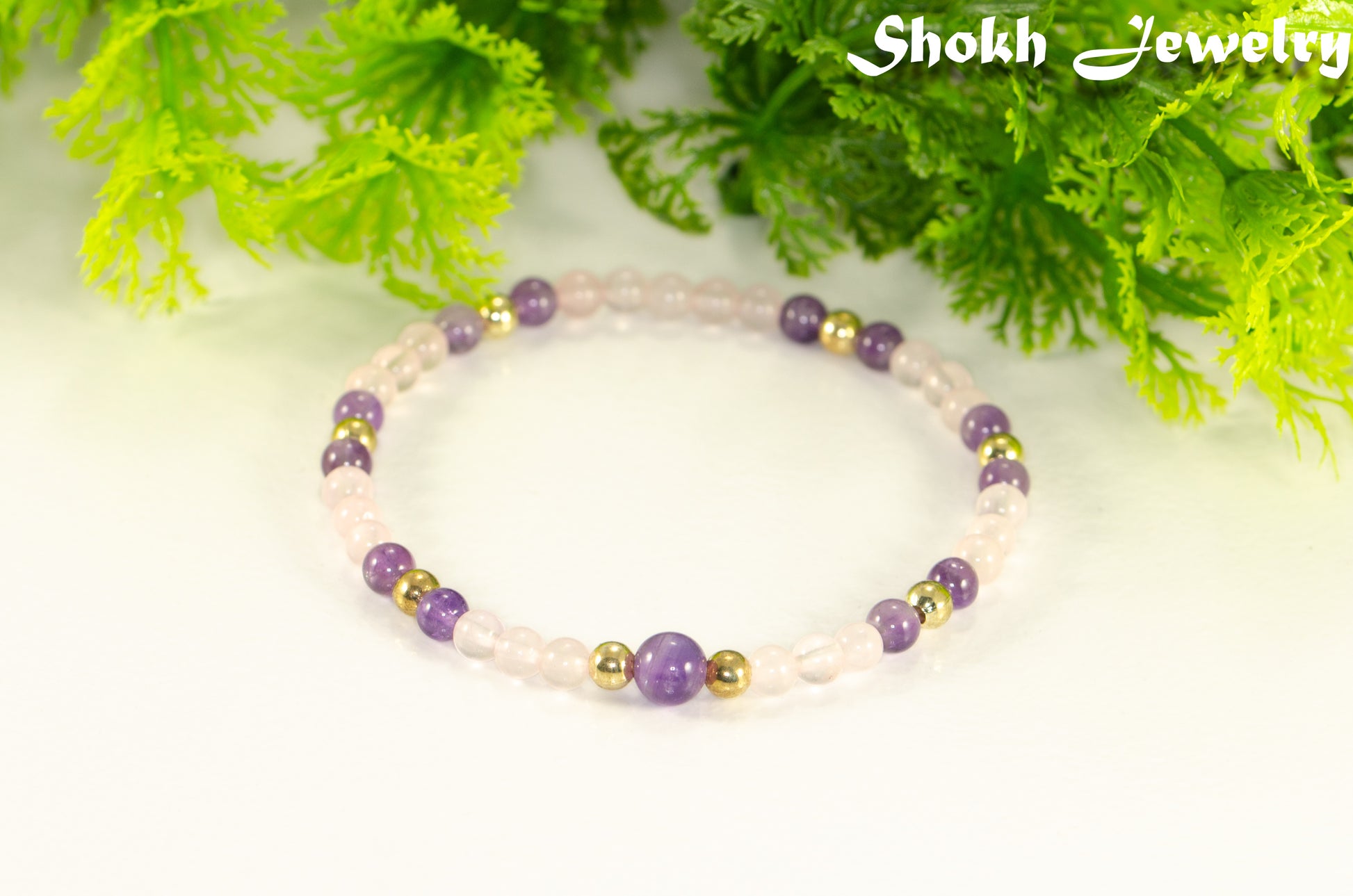 4mm Rose Quartz and Amethyst Bracelet with gold plated accent beads.