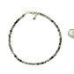 4mm Snowflake Obsidian Crystal Choker Necklace beside a dime.