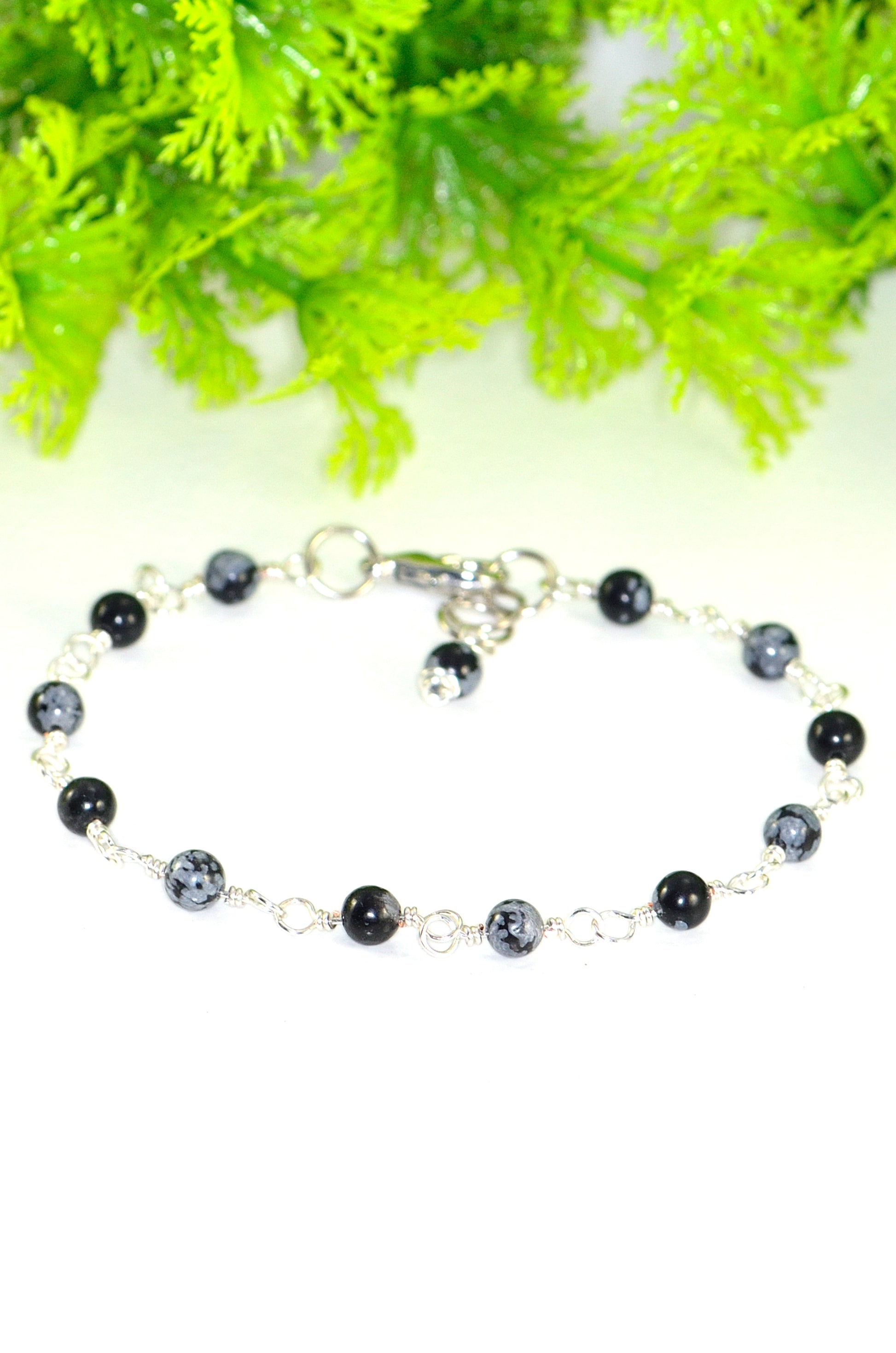 Close up of 4mm Snowflake Obsidian Link Chain Bracelet.