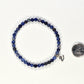 4mm Sodalite Bracelet with Initial beside a dime.
