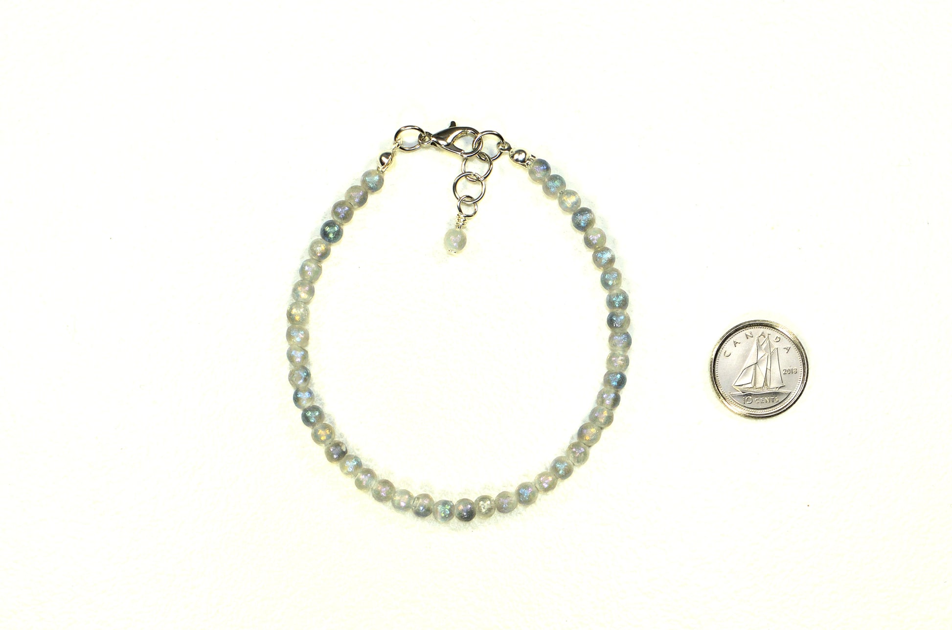 4mm Sparkly Selenite Bracelet with Clasp beside a dime.