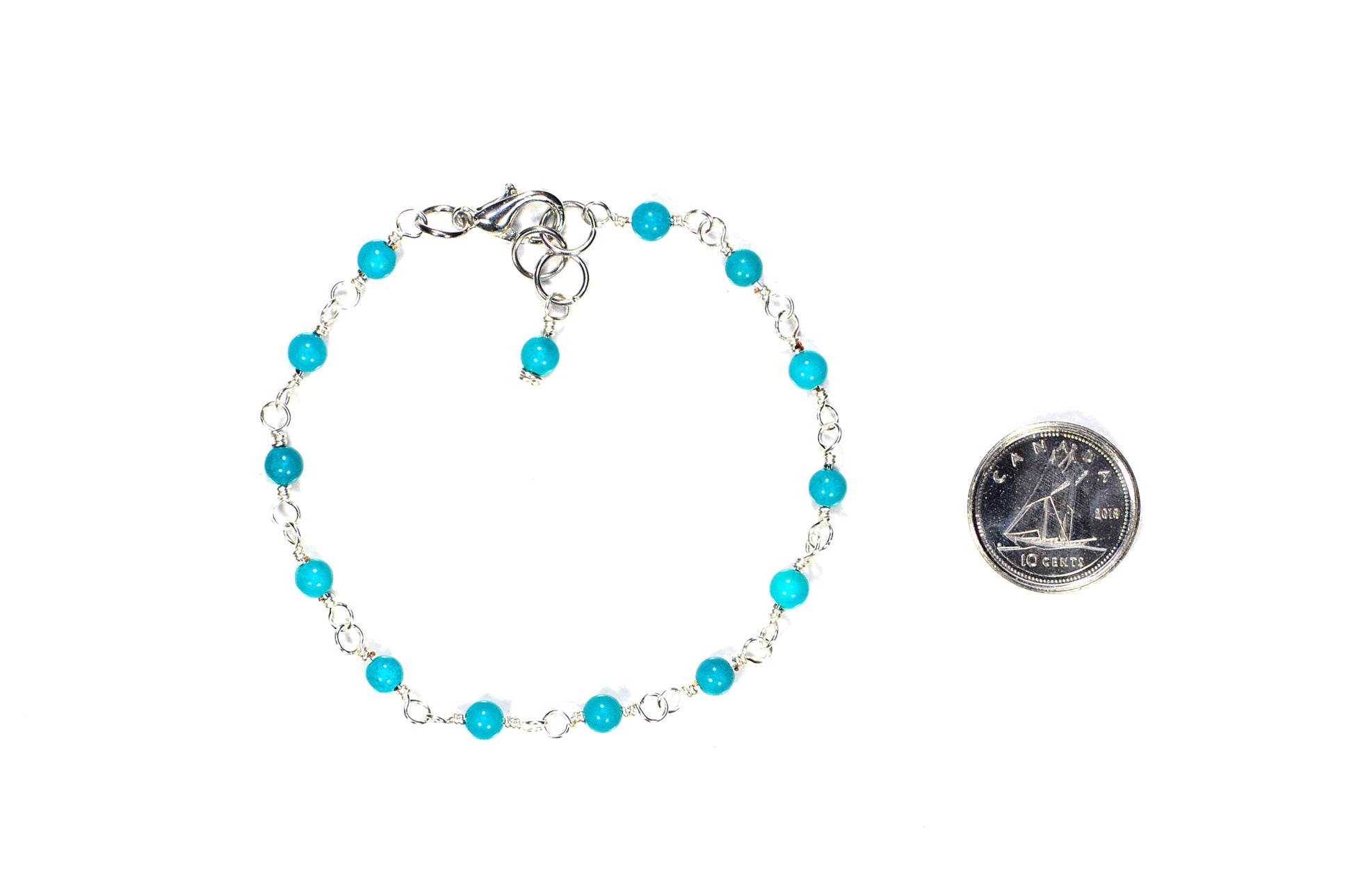 4mm Turquoise Beaded Link Bracelet beside a dime.