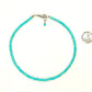 4mm Turquoise Howlite Choker Necklace beside a dime.