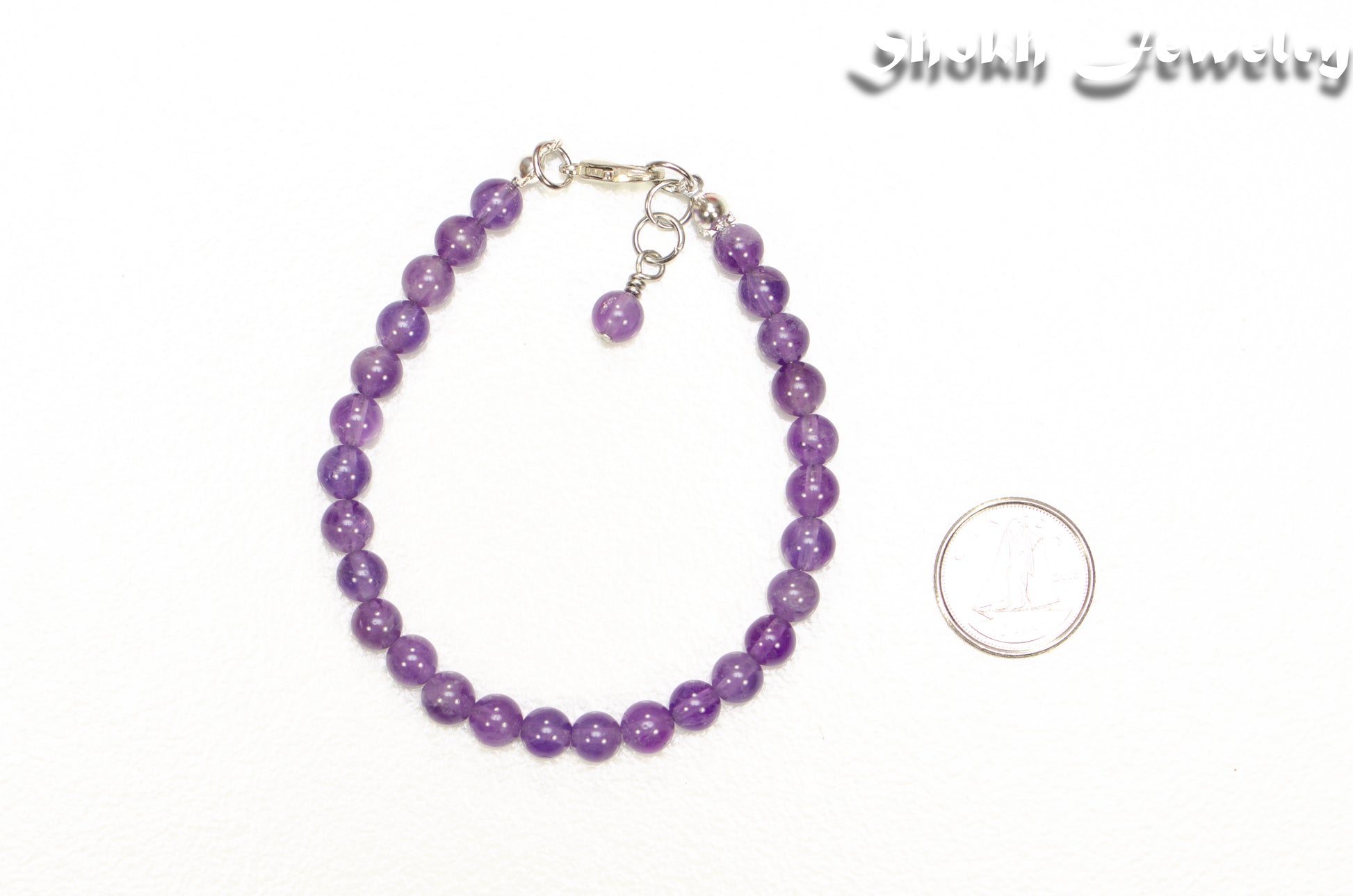 6mm Amethyst Anklet beside a dime.