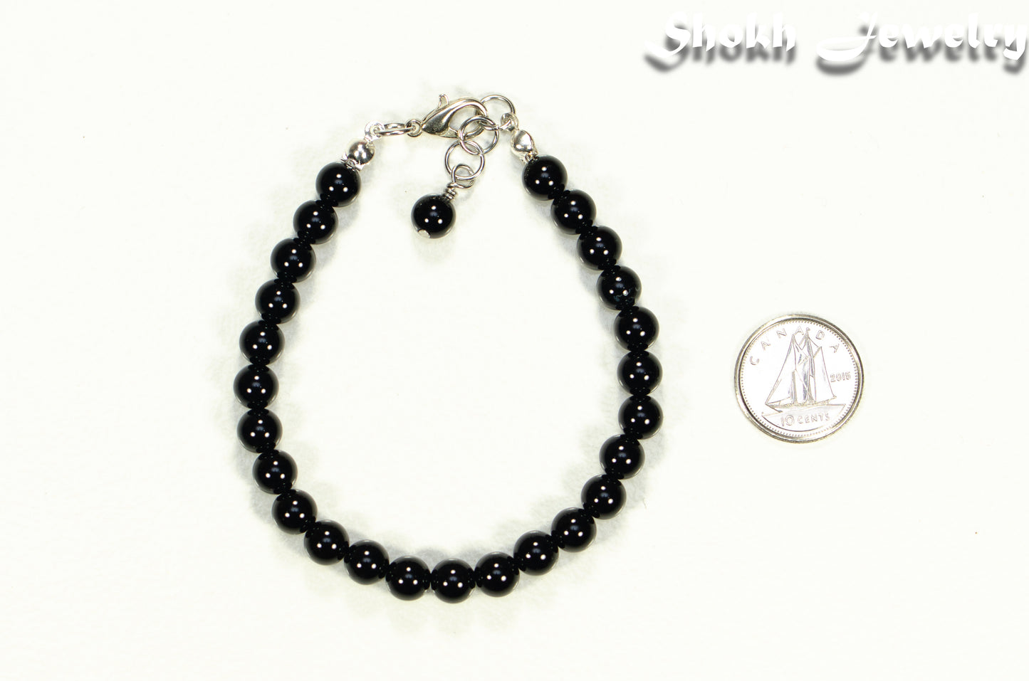 6mm Black Obsidian Beaded Bracelet beside a dime.
