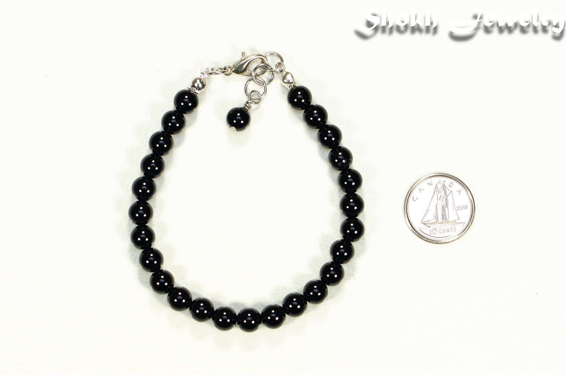 6mm Black Obsidian Beaded Bracelet beside a dime.