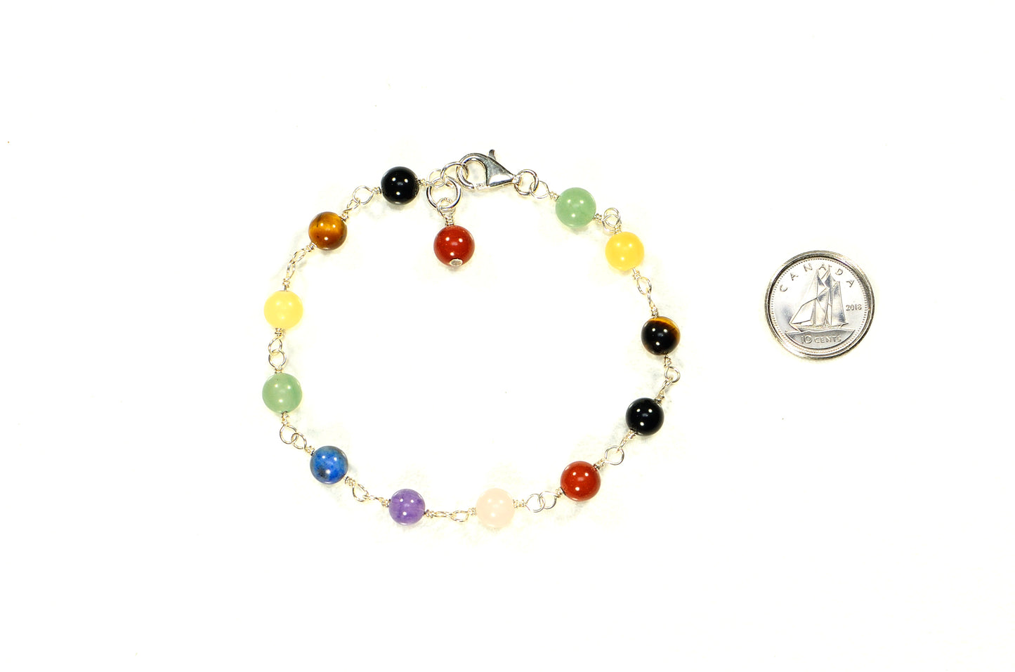 6mm Chakra Bracelet with Sterling Silver Clasp beside a dime.