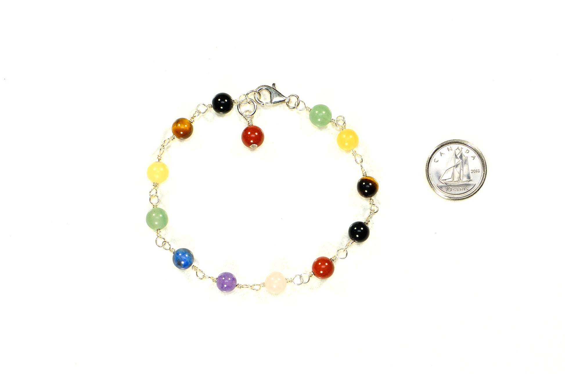 6mm Chakra Bracelet with Sterling Silver Clasp beside a dime.