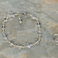  6mm Clear Quartz Link Bracelet beside a dime.