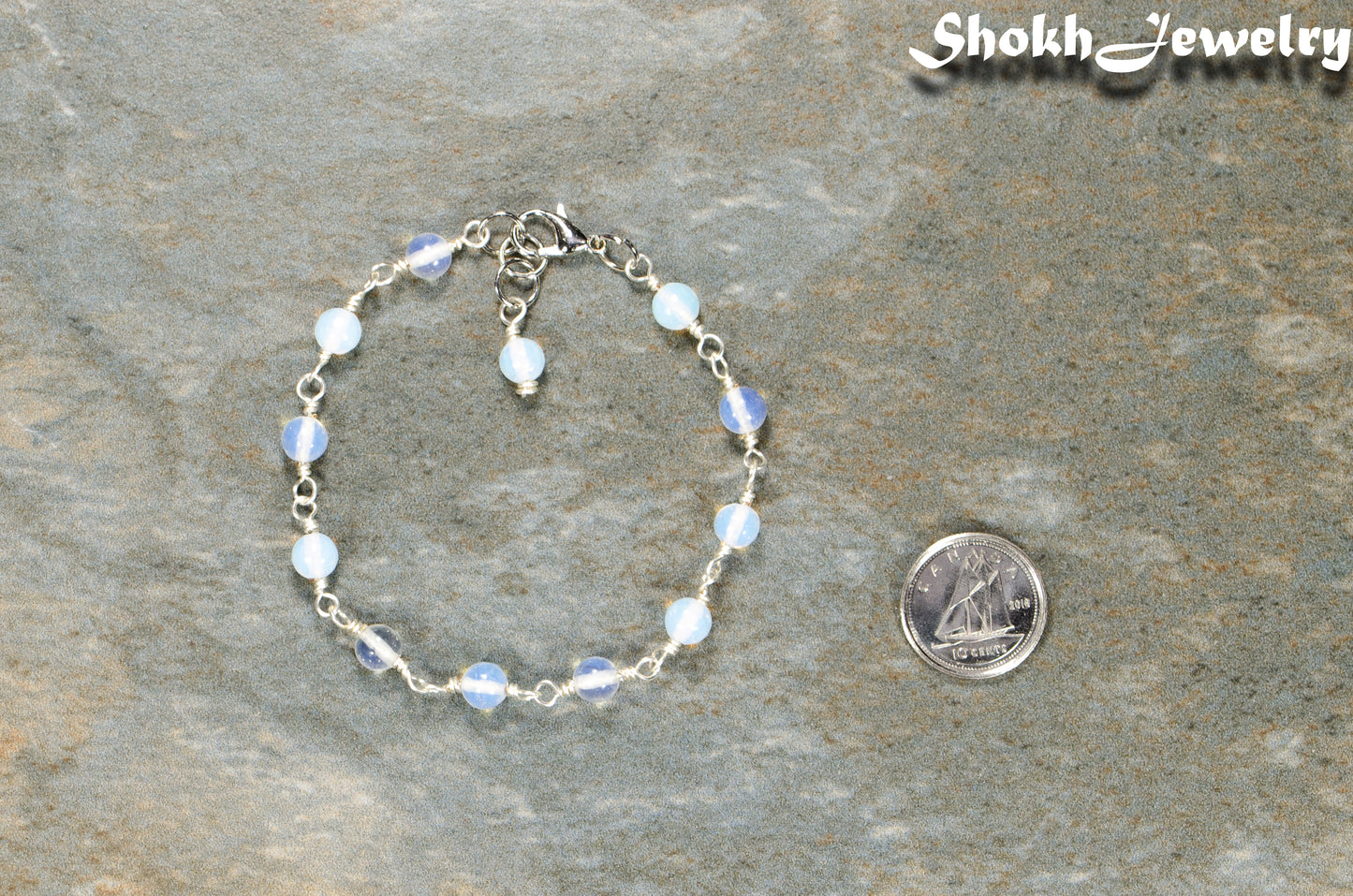 6mm Clear White Opal Link Chain anklet beside a dime.