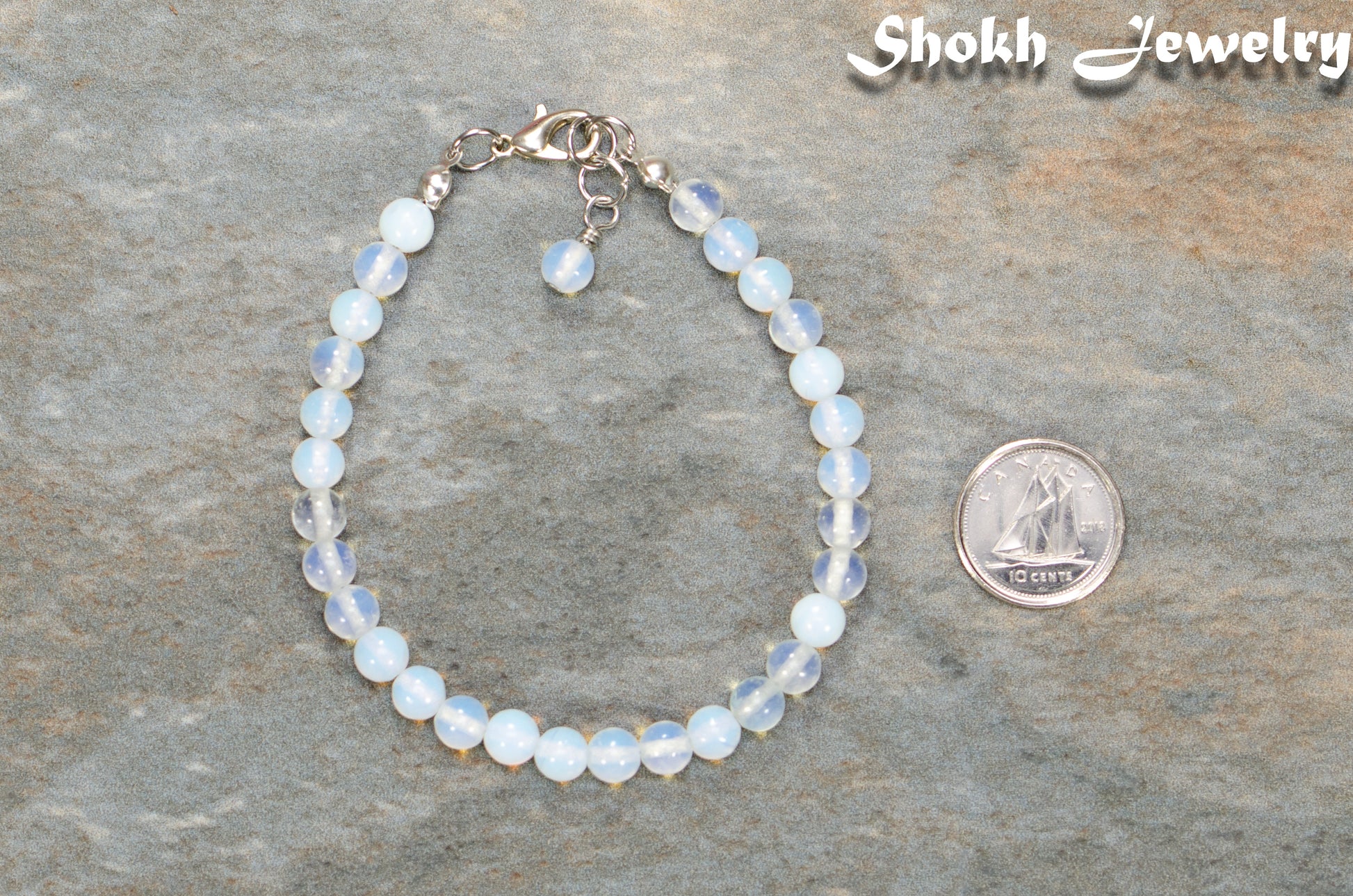 6mm Clear White Opalite Beaded Anklet beside a dime.