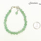 6mm Green Aventurine Beaded Bracelet beside a dime.