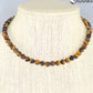 6mm Natural Tiger's Eye Choker Necklace displayed on a bust.