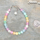 6mm Rainbow Selenite Anklet beside a dime.
