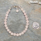 6mm Rose Quartz Beaded Bracelet beside a dime.