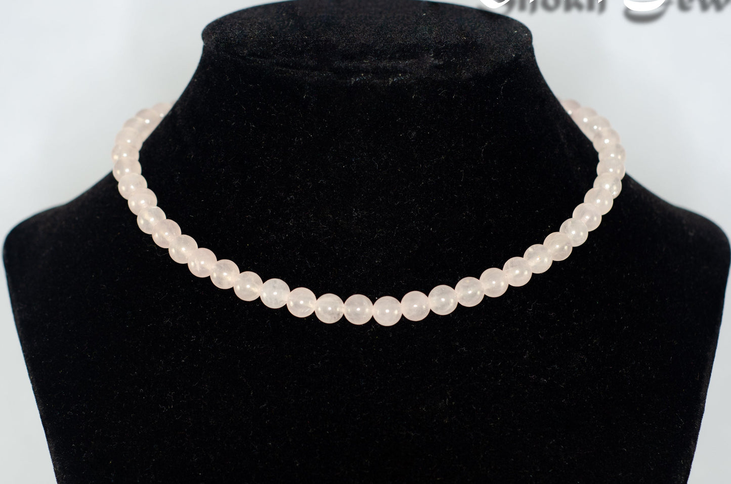 6mm Rose Quartz Crystal Choker Necklace displayed on a bust.

