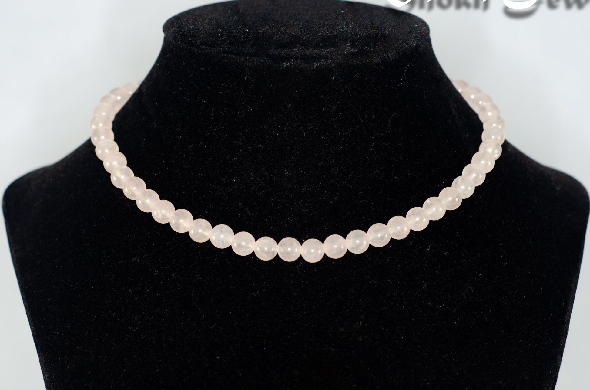 6mm Rose Quartz Crystal Choker Necklace displayed on a bust.
