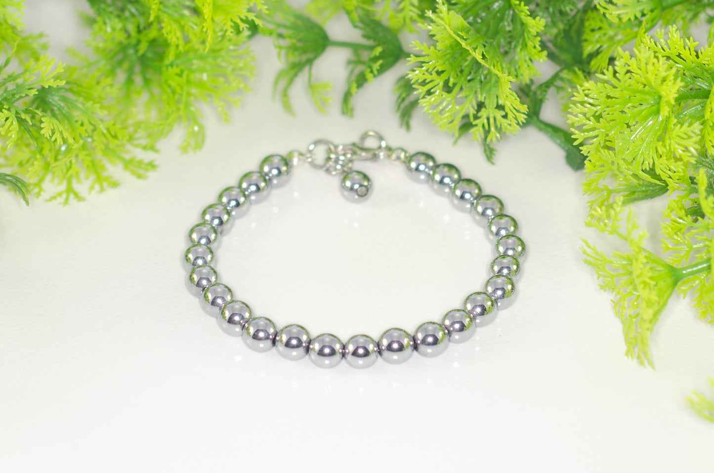 6mm Silver Hematite Stone Bracelet with Clasp and a dangle.