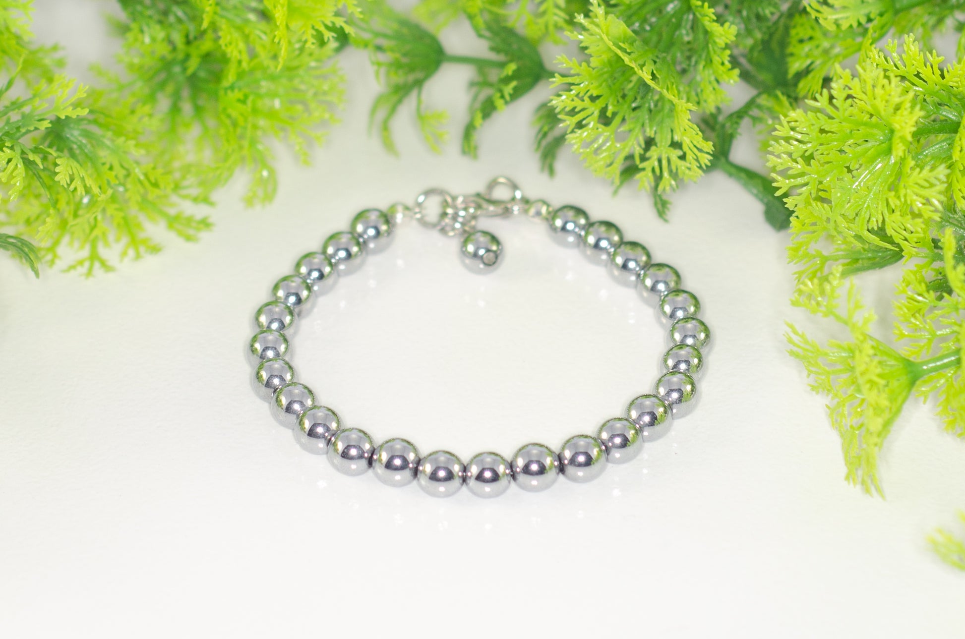 6mm Silver Hematite Stone Bracelet with Clasp and a dangle.