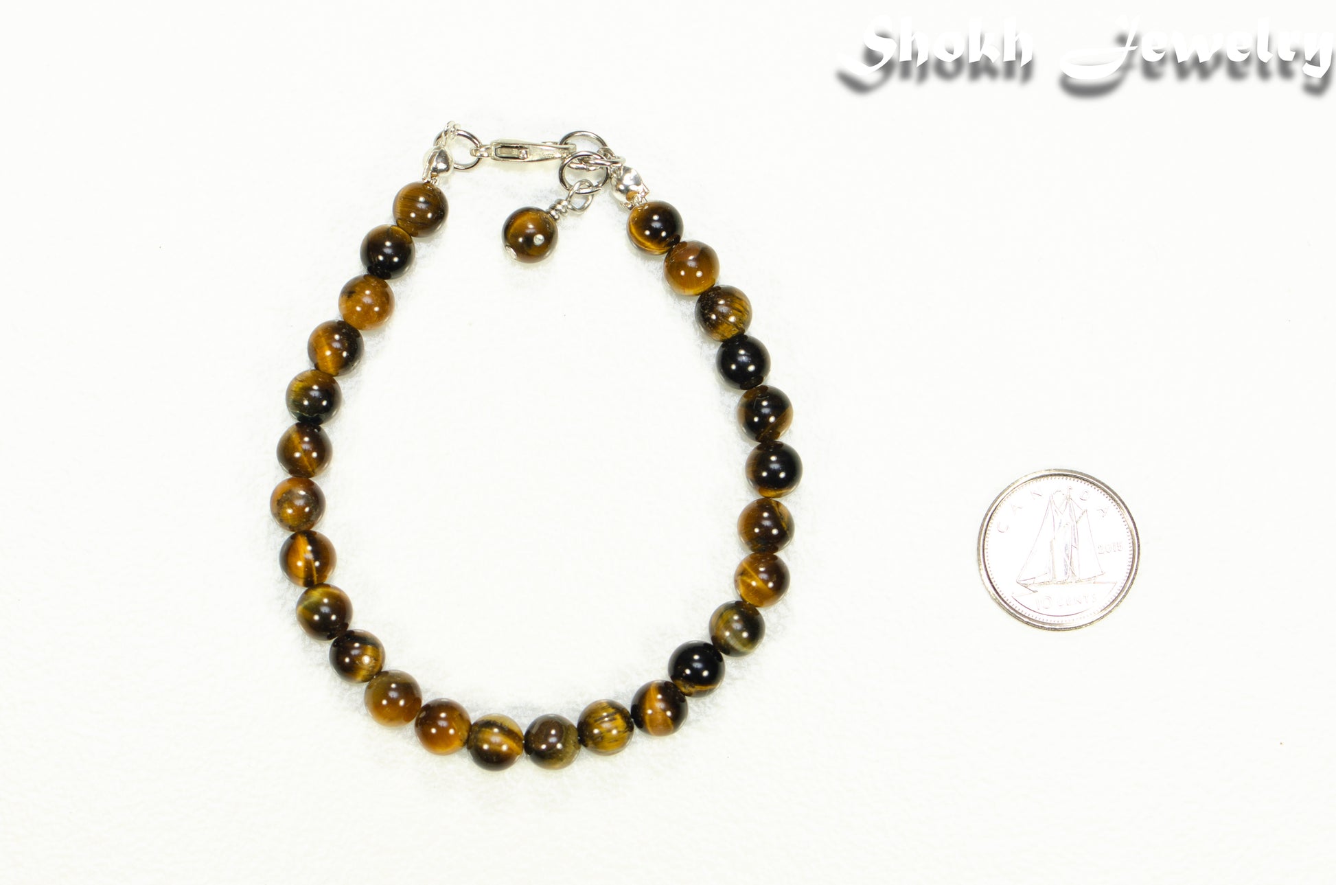 6mm Tiger's Eye Beaded Bracelet beside a dime.
