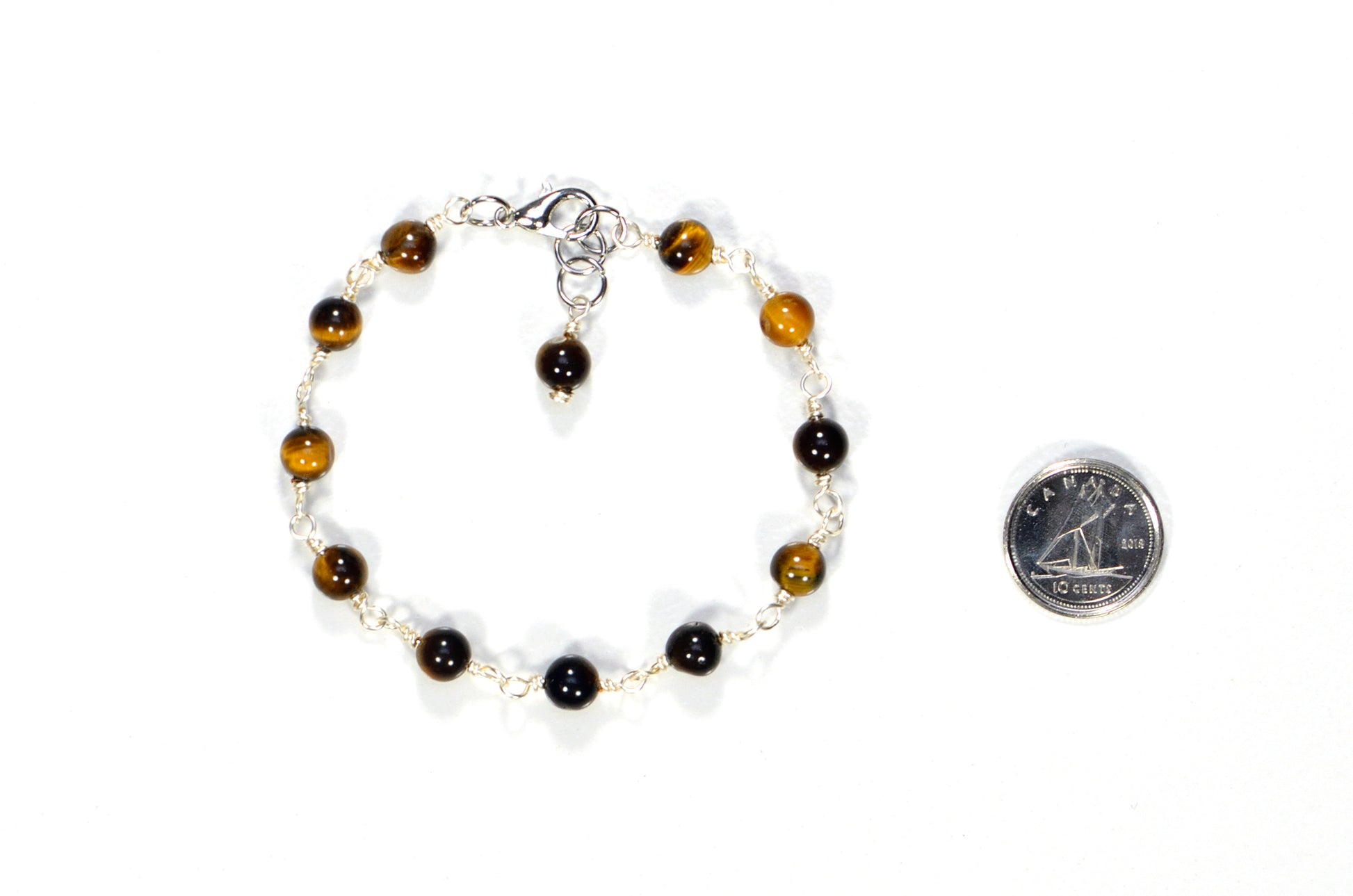 6mm Tiger's Eye Link Chain Bracelet beside a dime.