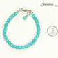 6mm Turquoise Howlite Beaded Anklet beside a dime.