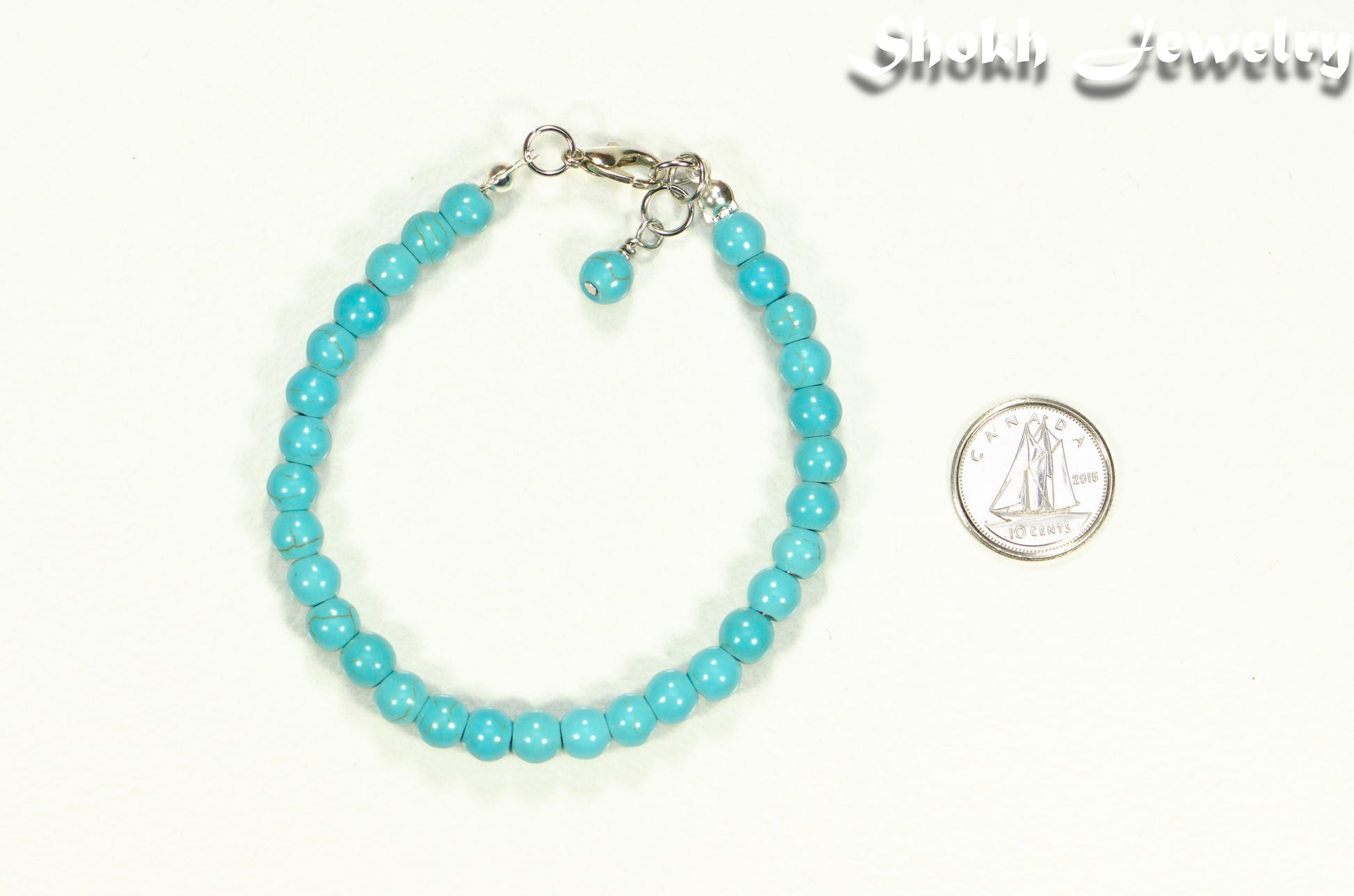 6mm Turquoise Howlite Beaded Anklet beside a dime.