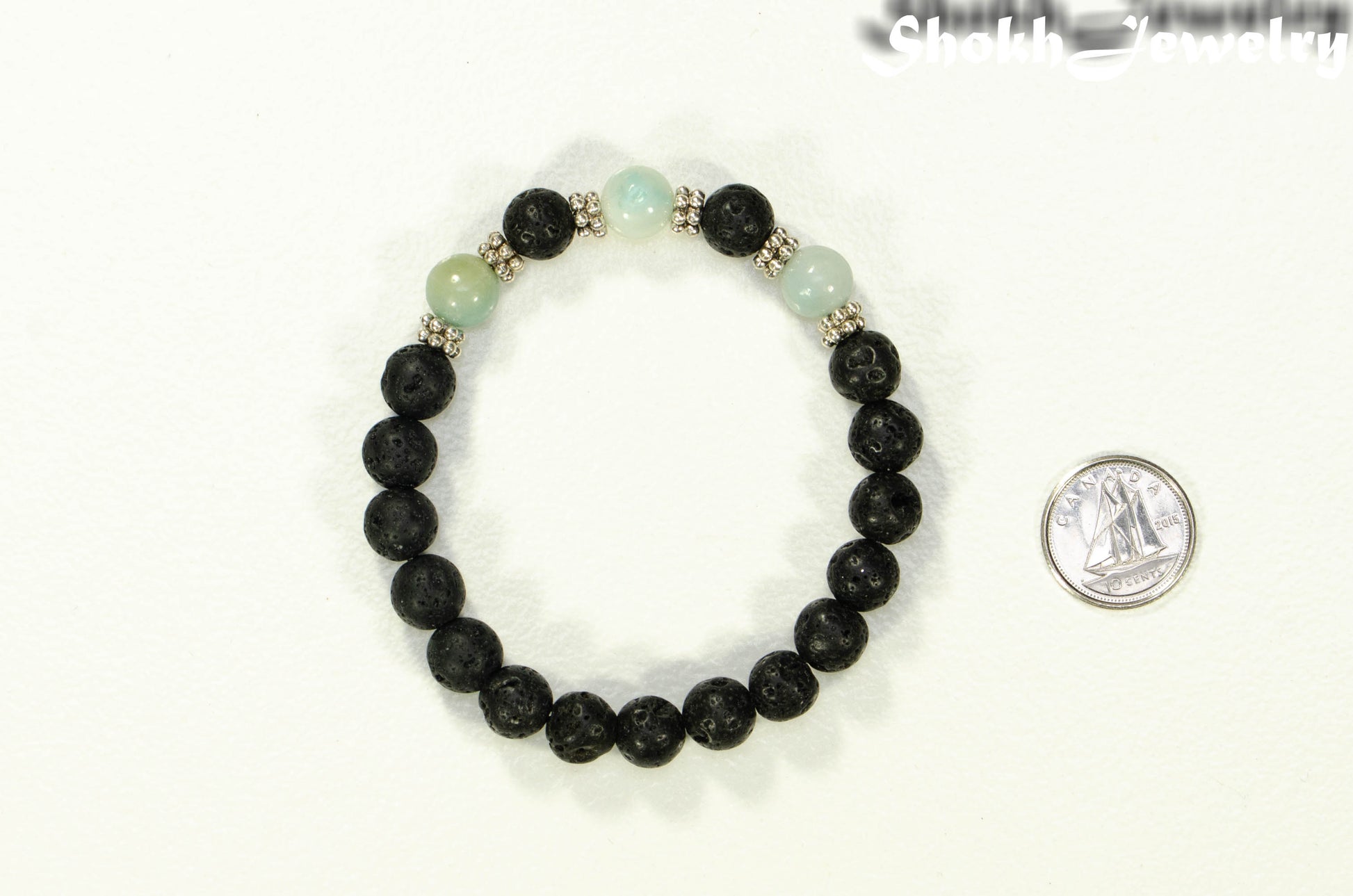 8mm Black Lava Stone and Amazonite Bracelet beside a dime.