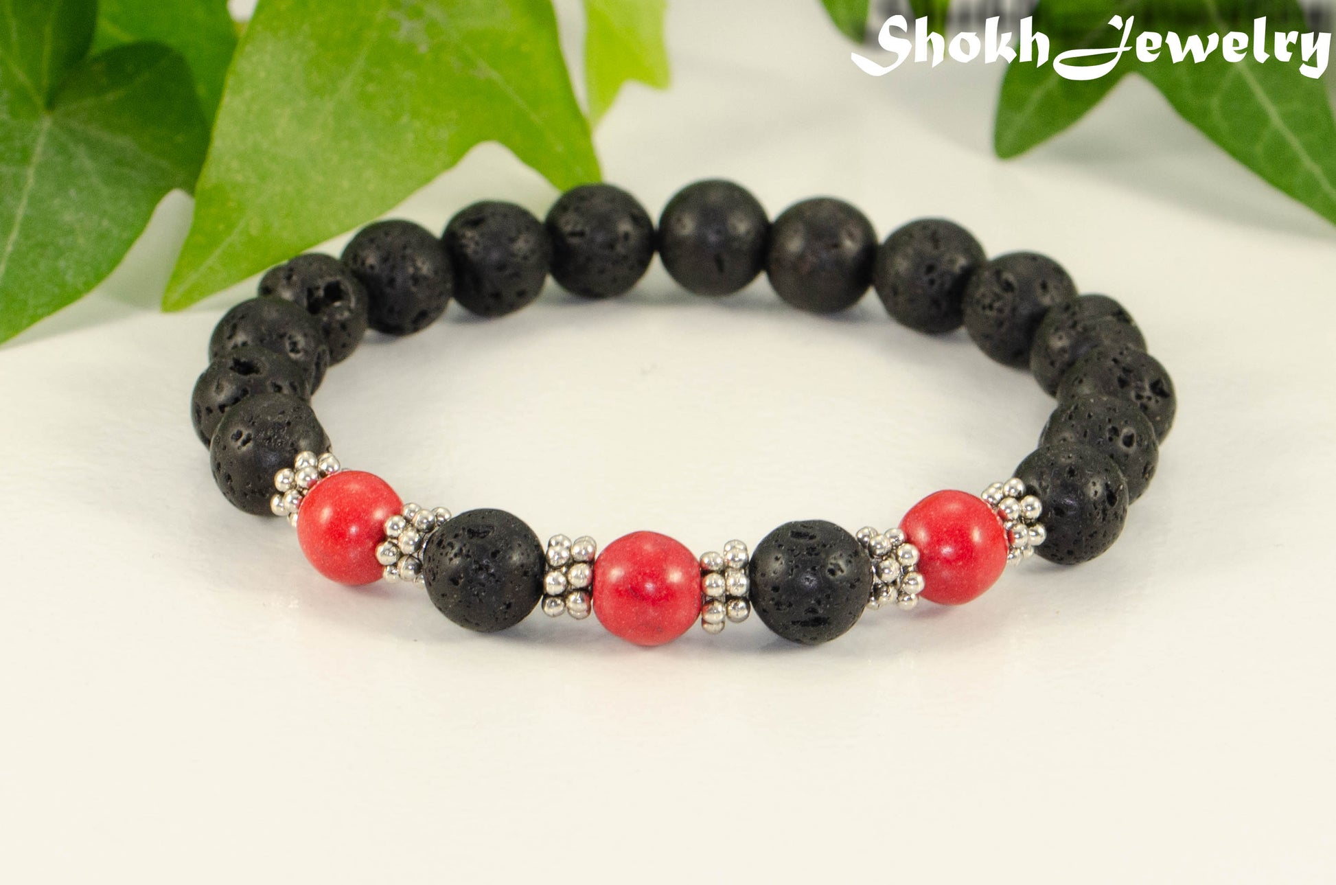 Close up of 8mm Black Lava Stone and Red Howlite Bracelet.