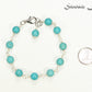 8mm Turquoise Howlite Link Anklet beside a dime.
