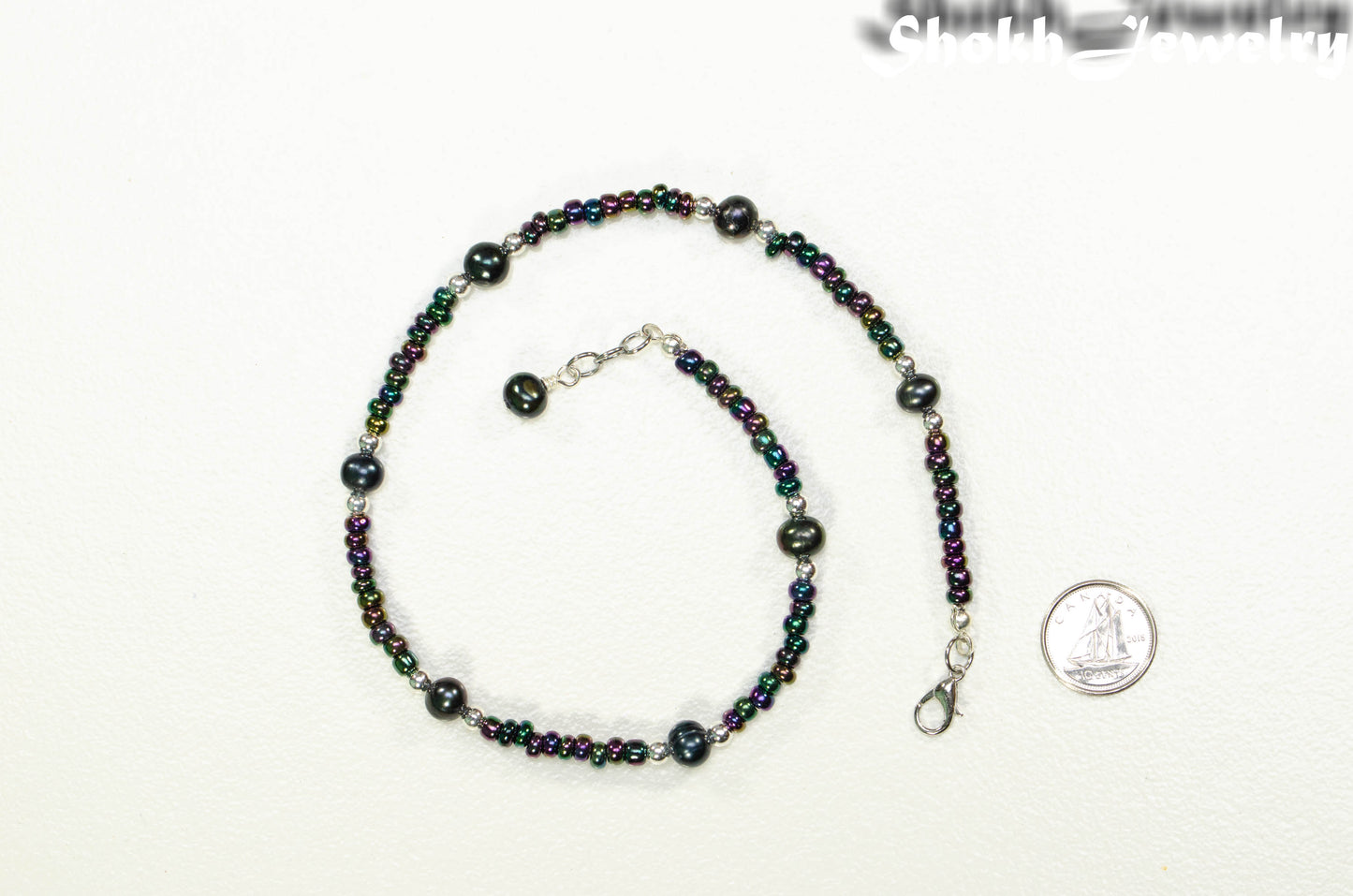 Black Freshwater Pearl and Seed Bead Choker Necklace beside a dime.
