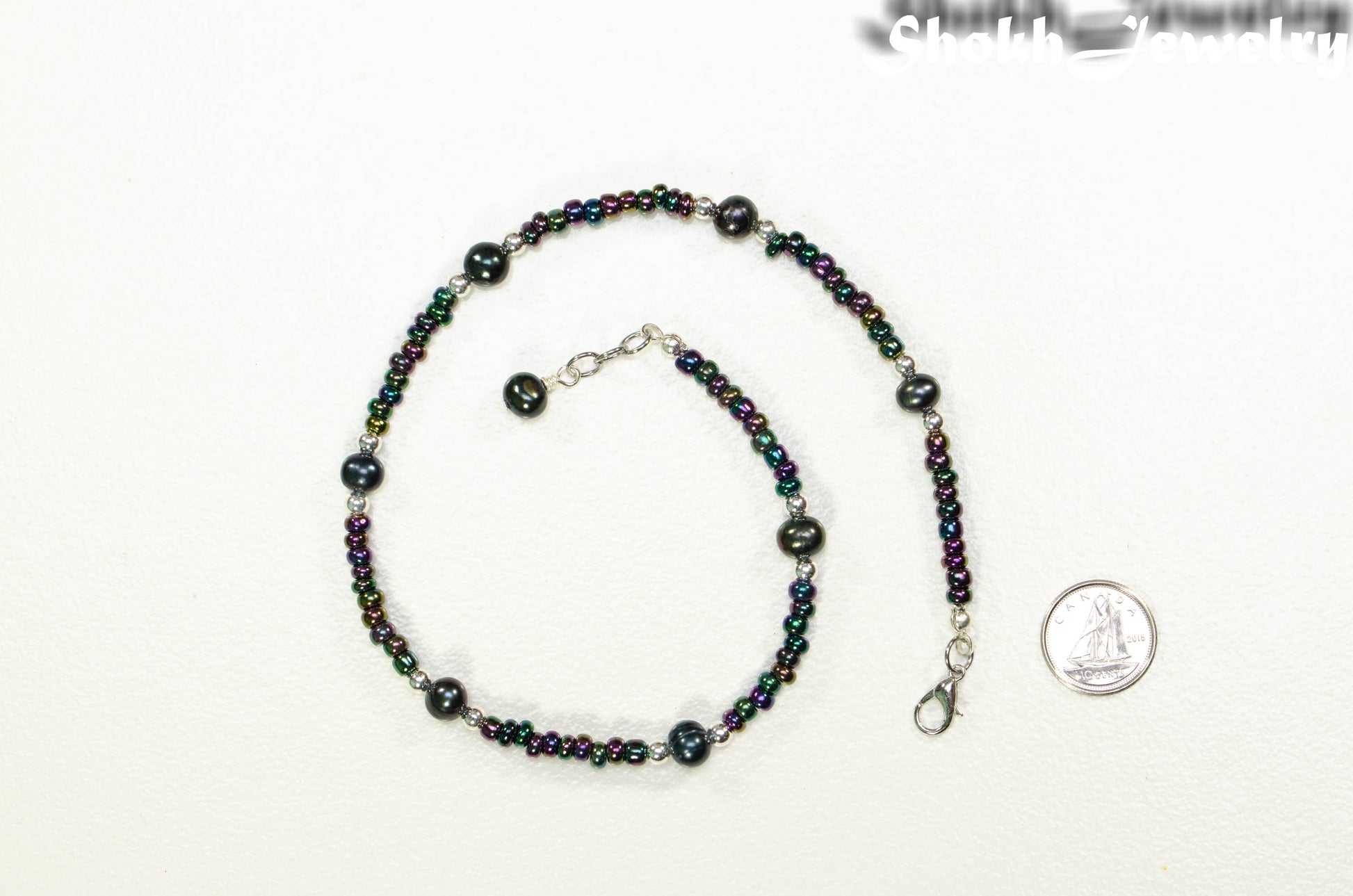 Black Freshwater Pearl and Seed Bead Choker Necklace beside a dime.