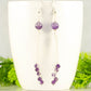 Cascading Amethyst Crystal Drop Earrings displayed on a coffee mug.