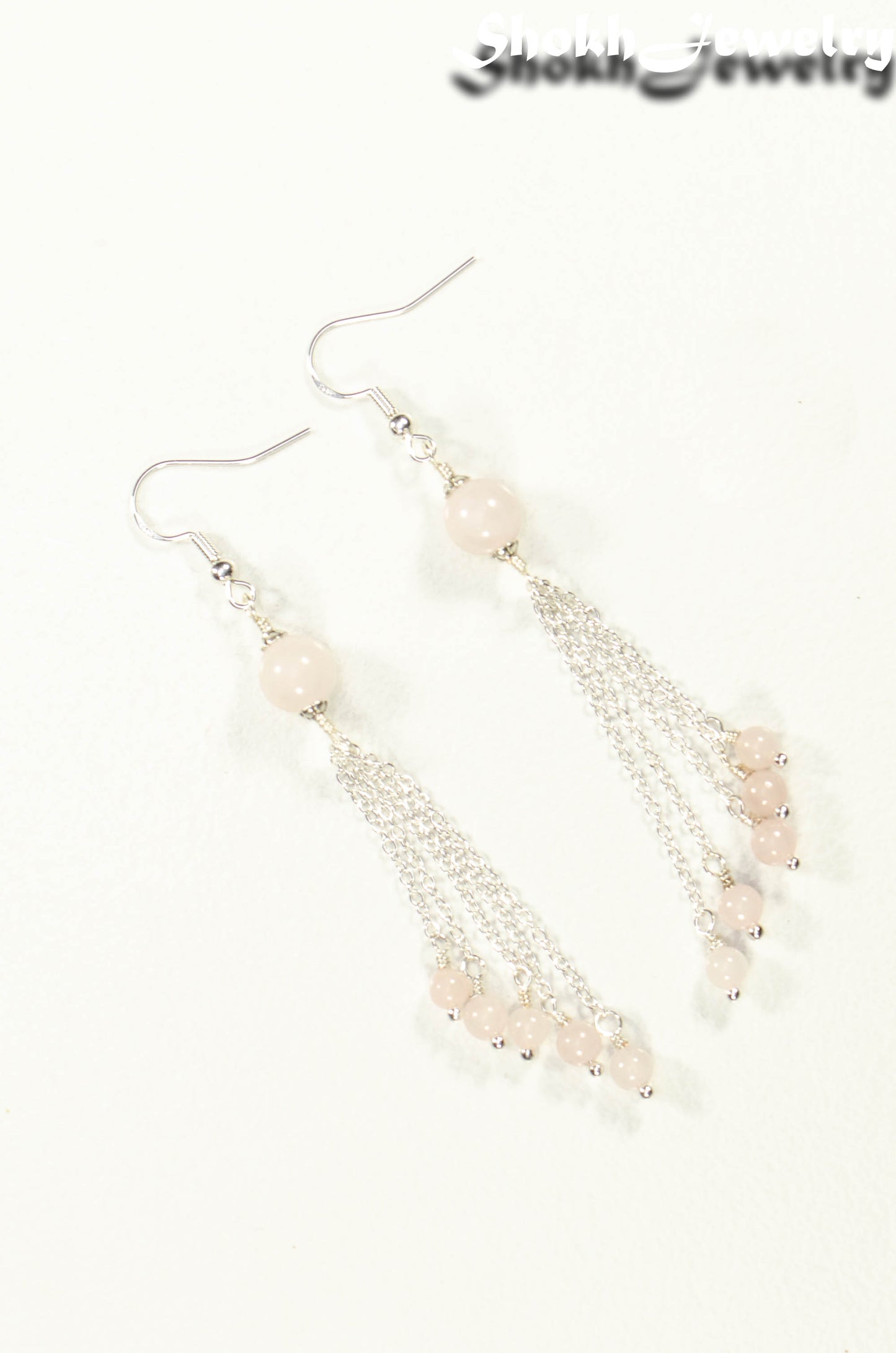 Top view of Cascading Rose Quartz Crystal Drop Earrings.