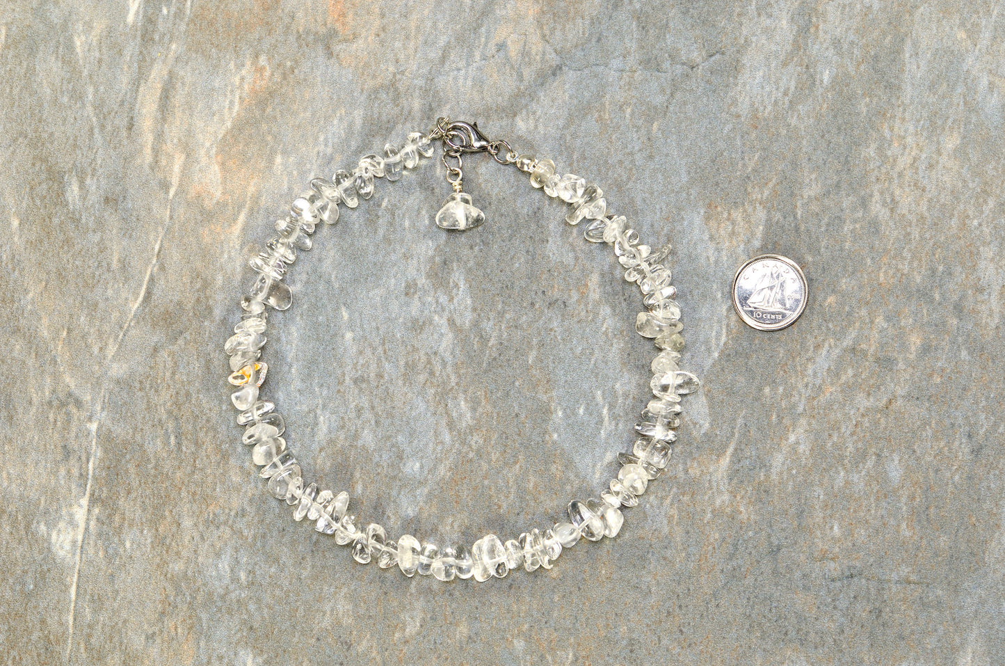 Clear Quartz Crystal Chip Anklet beside a dime.