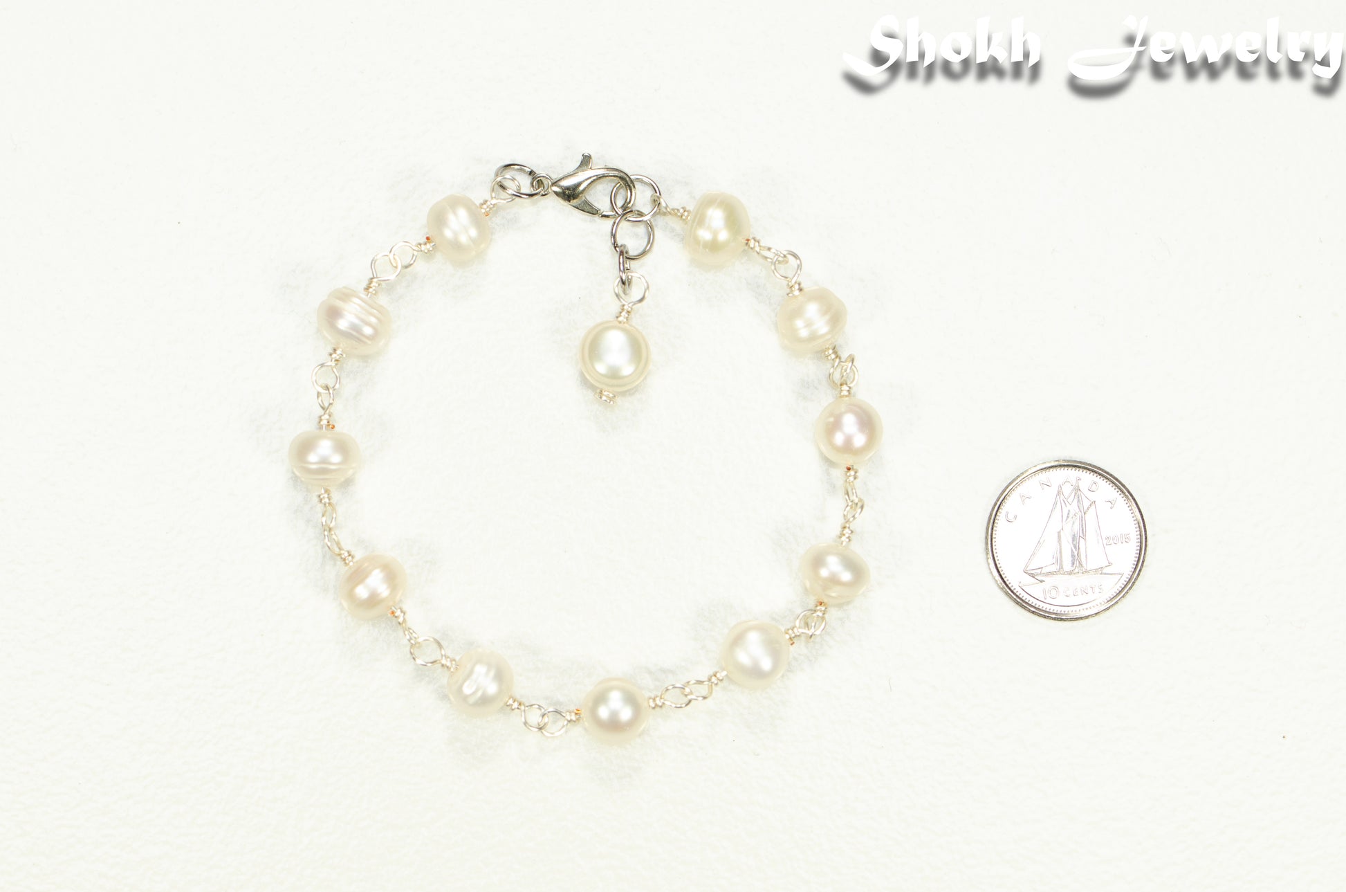Handmade Freshwater Pearls Link Chain Bracelet on white background.