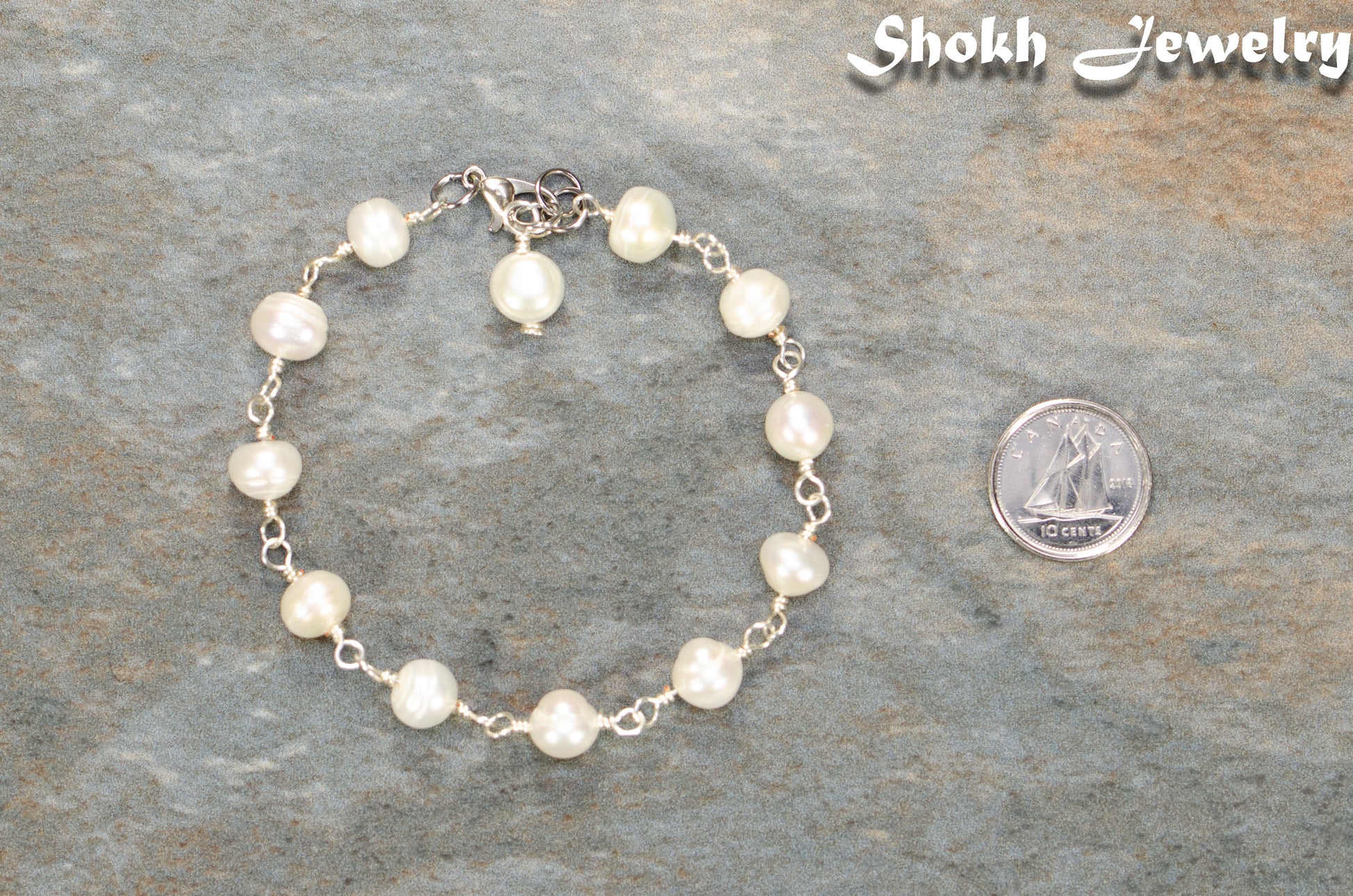 Handmade Freshwater Pearls Link Chain Bracelet beside a dime.