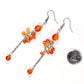 Long Stainless Steel Chain and Carnelian Earrings beside a dime.
