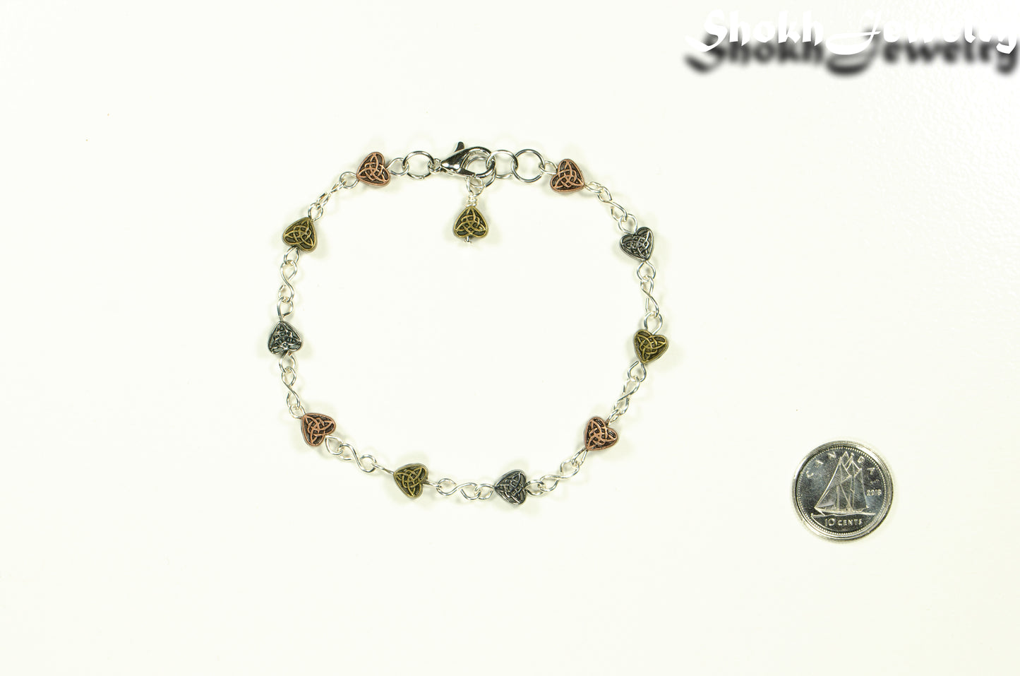 Multi Metal Heart Link Anklet beside a dime.