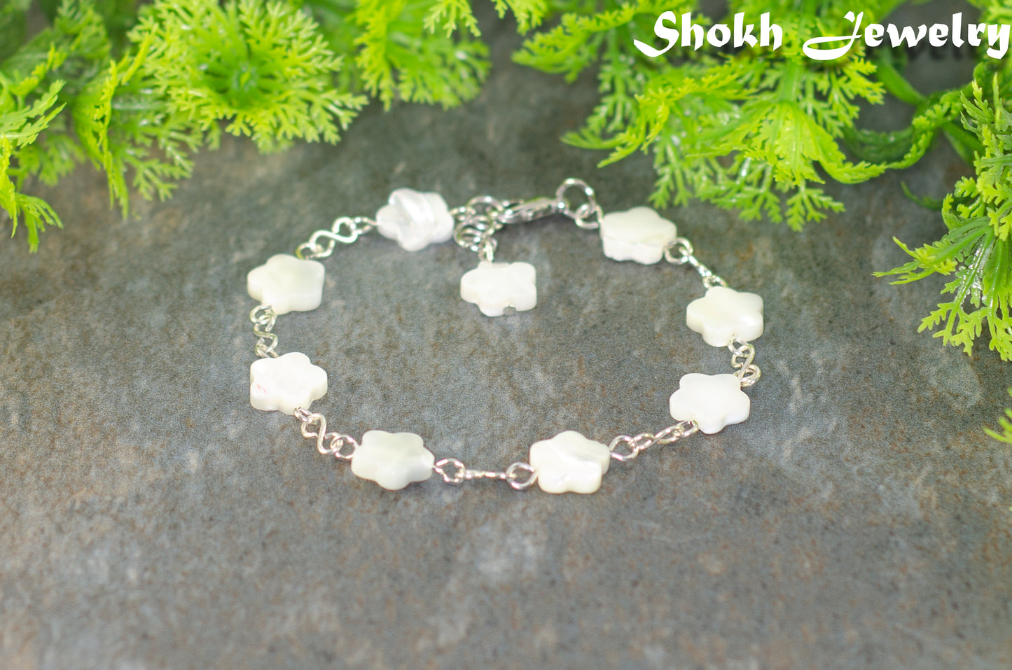 Natural Seashell Flower Link Bracelet with lobster claw clasp and a dangle.