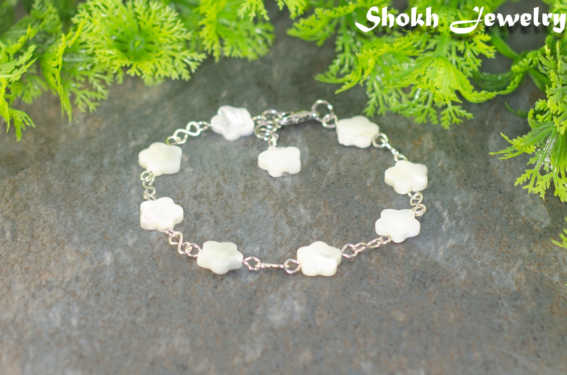 Natural Seashell Flower Link Bracelet with lobster claw clasp and a dangle.