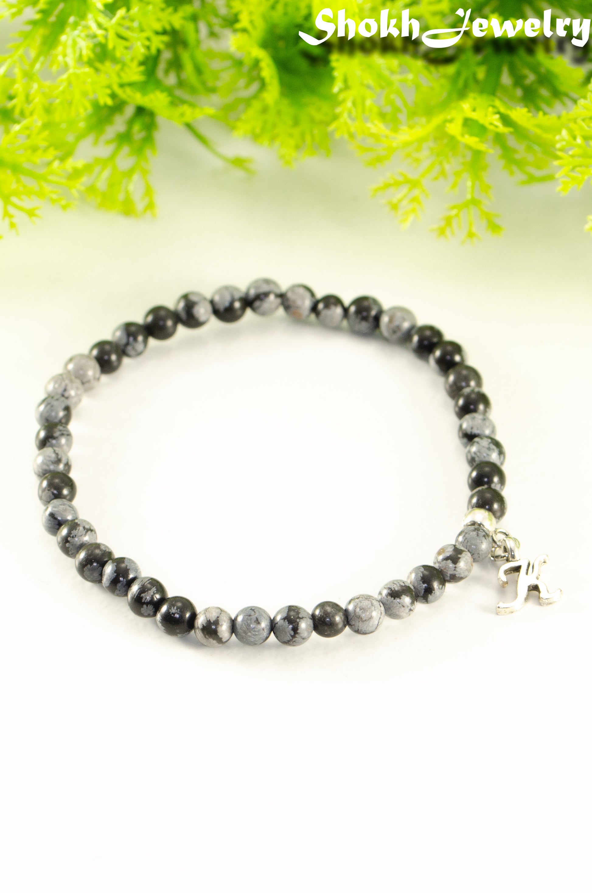 Close up of 4mm Snowflake Obsidian Bracelet with Initial.