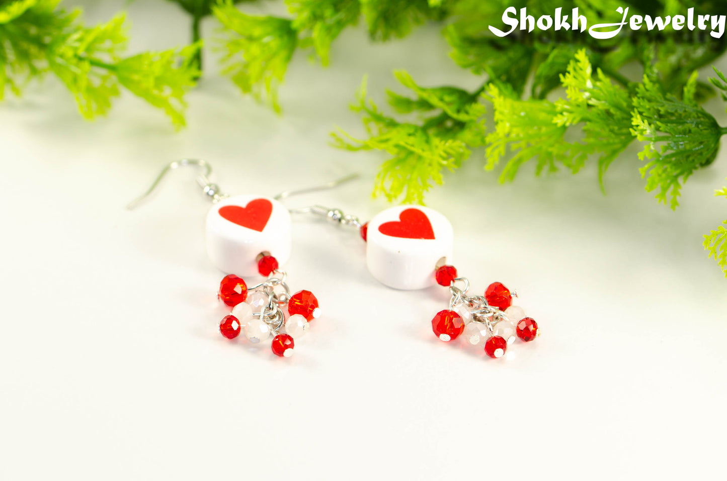 Close up of Statement Red Heart Ceramic Bead Earrings.