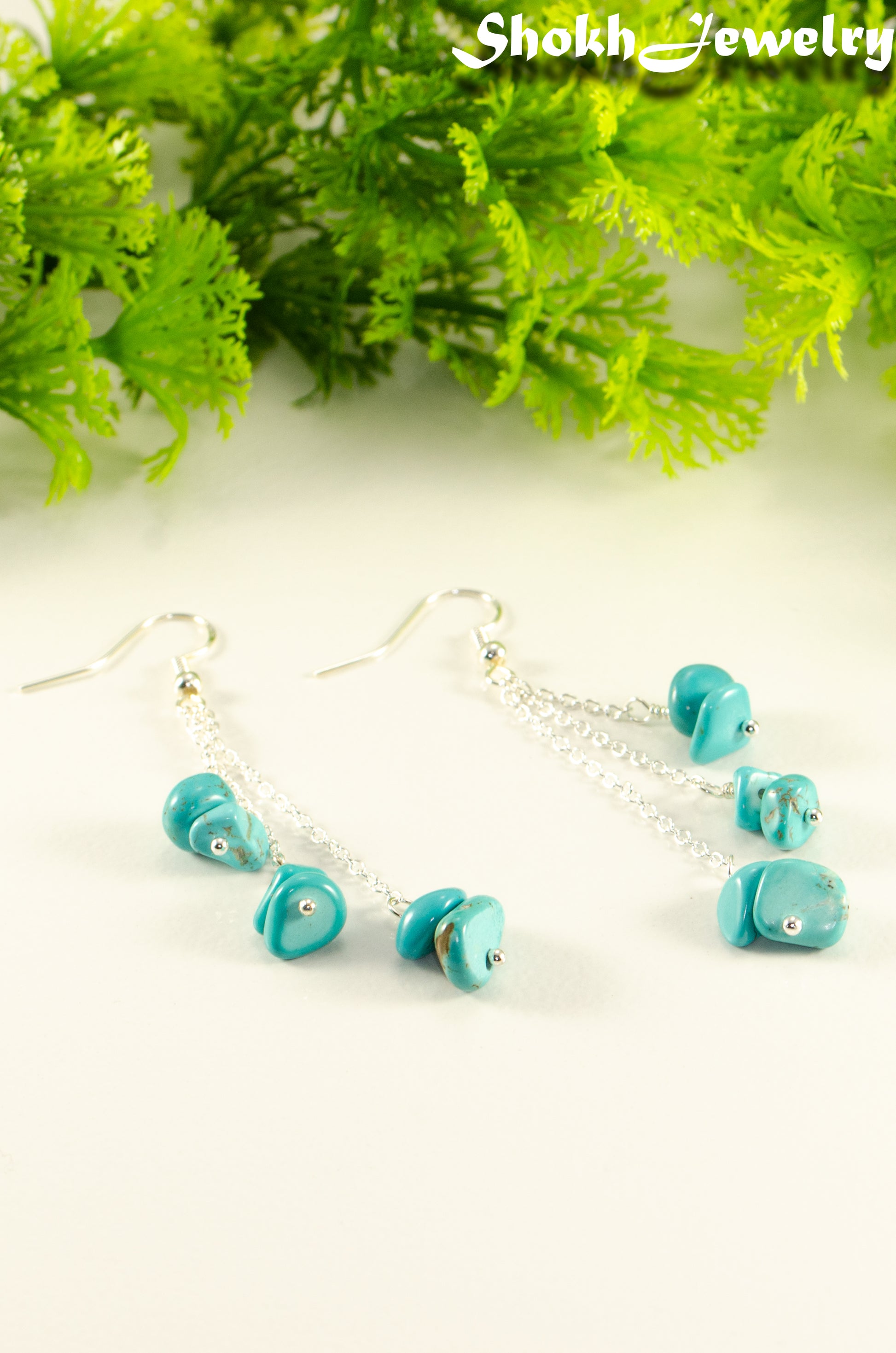 Close up of Long Silver Plated Chain and Turquoise Crystal Chip Earrings.