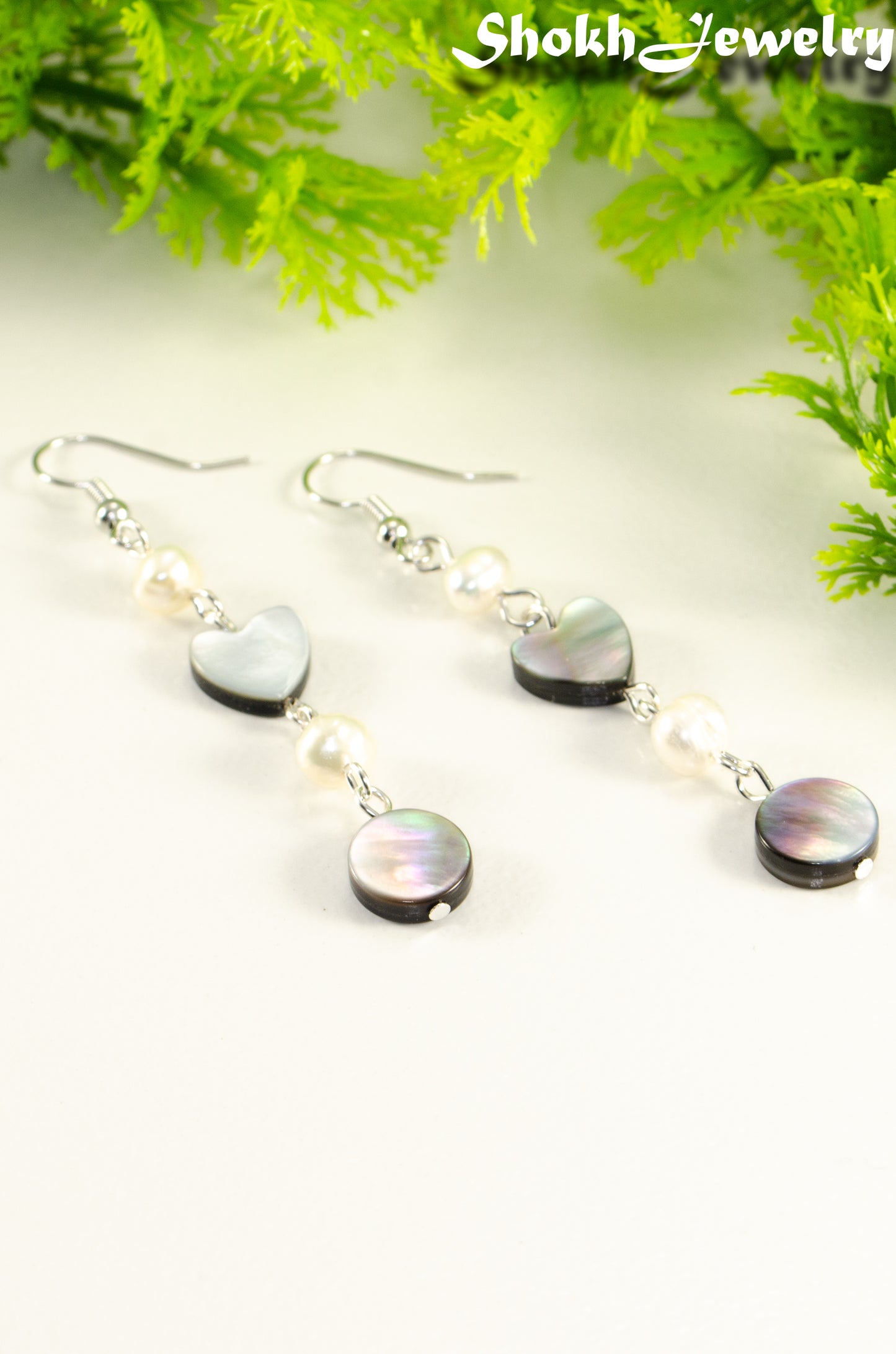 Close up of Long Grey Seashell and Freshwater Pearl Earrings