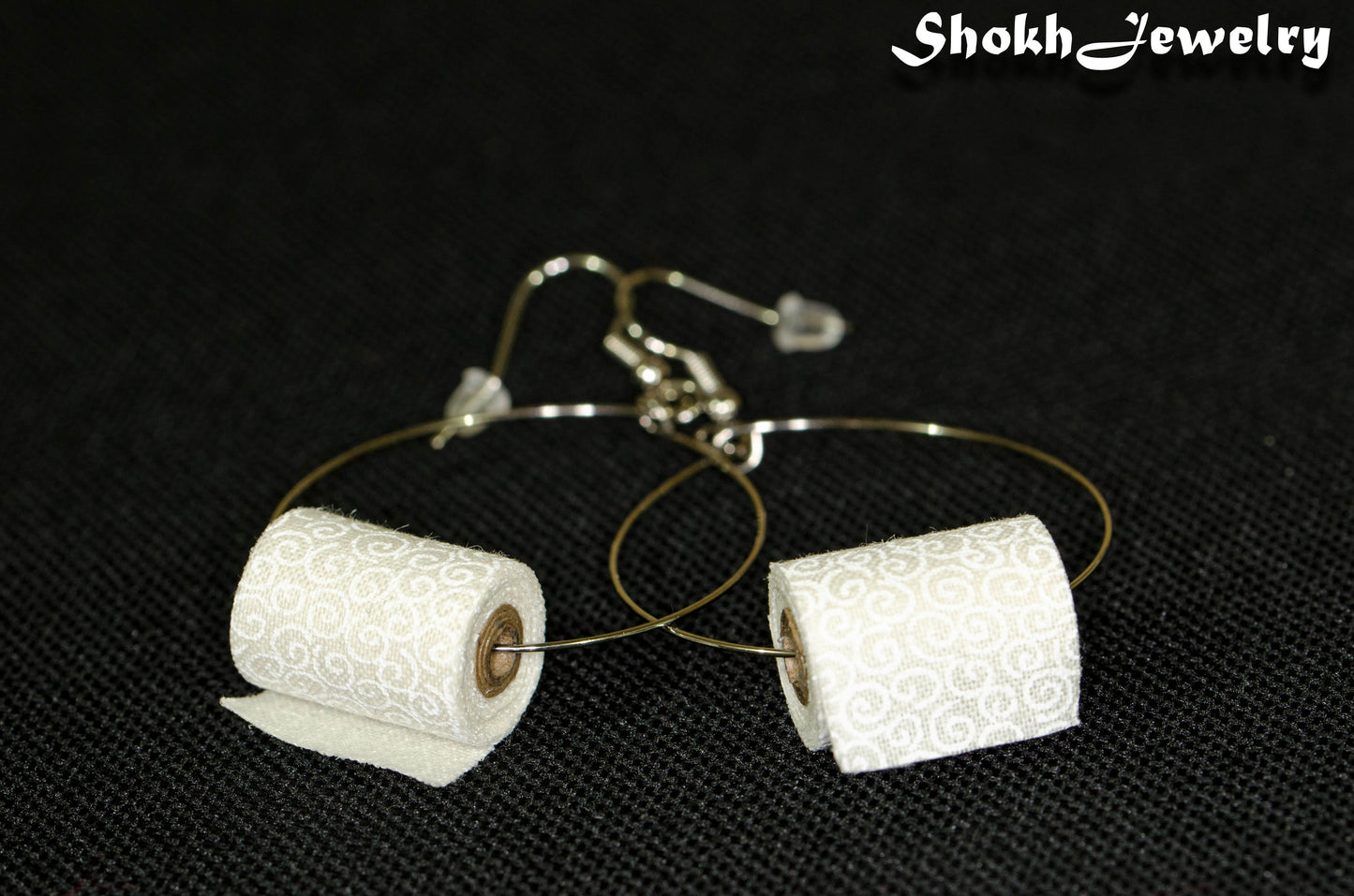 Close up of Large Miniature Toilet Paper Roll Earrings.