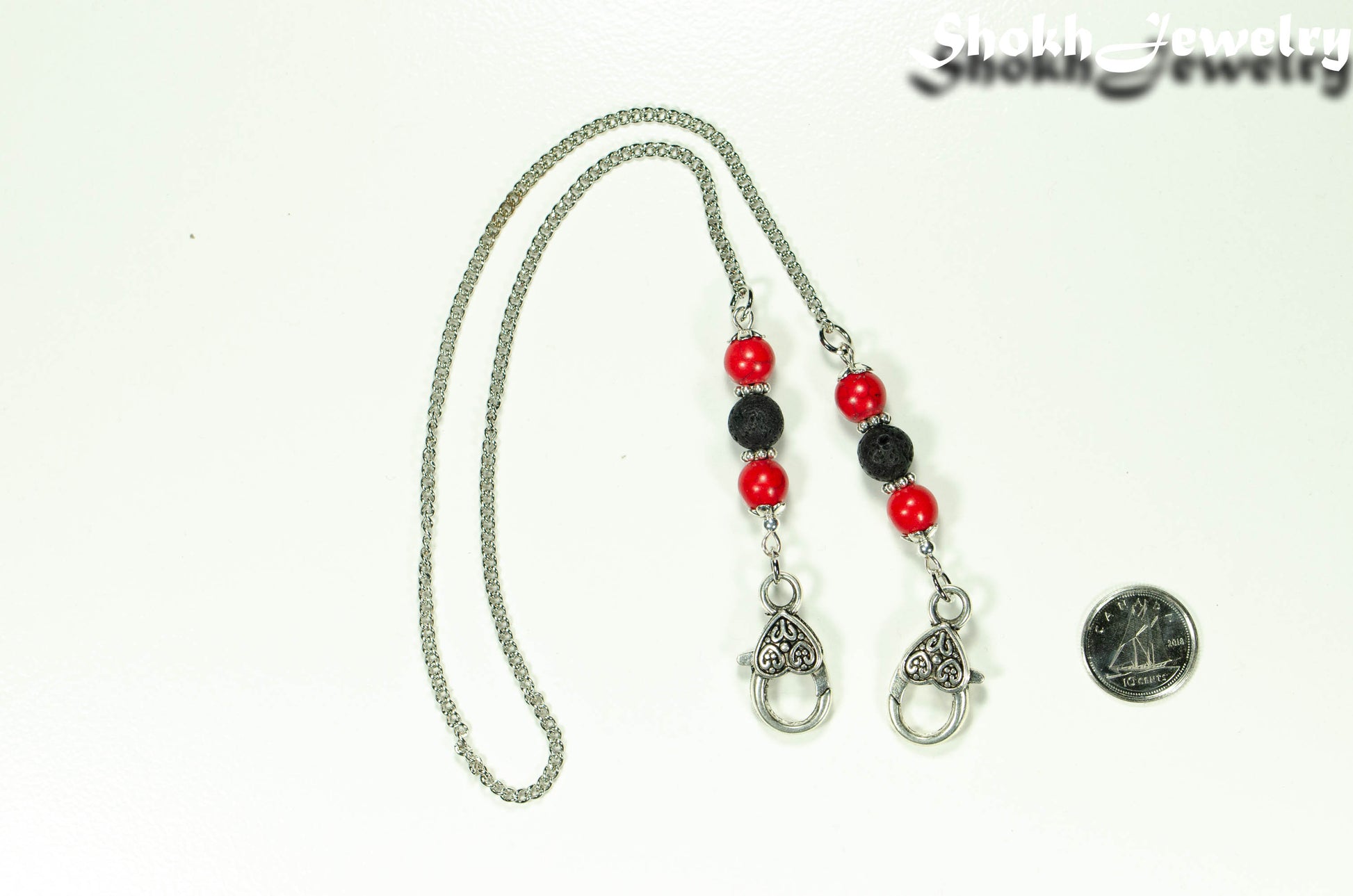 8mm Red Howlite and Black Lava Stone Eyeglass Chain beside a dime.